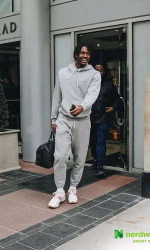 Tyrese Maxey’s Outfit in New Balance Hoodie & Louis Vuitton Bag (2023)
