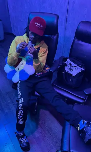 Onlybino wearing Supreme cap