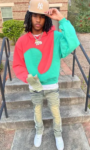 Lil Darius wearing New Era cap