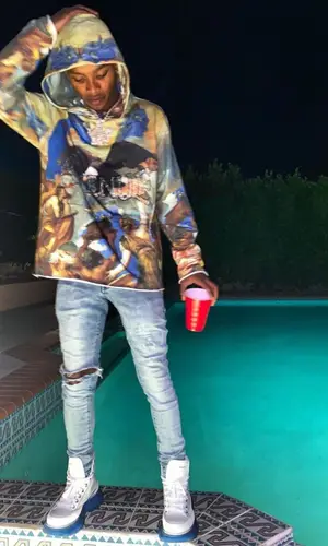 Calboy wearing Alexander McQueen boots