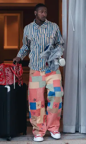 Terry Rozier’s Outfit in KidSuper Jacket, Amiri Bag & Apple (2023)