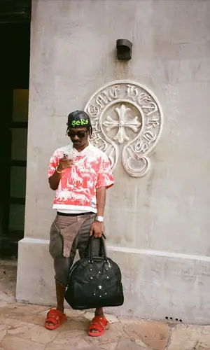 Bruce Ray wearing Chrome Hearts bag