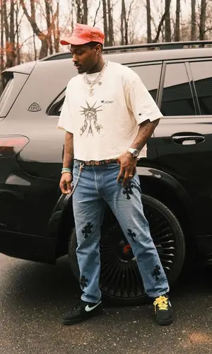 Stefon Diggs’ Outfit in Louis Vuitton Jacket, Chrome Hearts Jeans & Nike Sneakers (2023)
