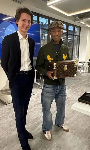 Pharrell Williams’ Outfit in Celine Jeans, Adidas Sneakers & Louis Vuitton Hat (2023)
