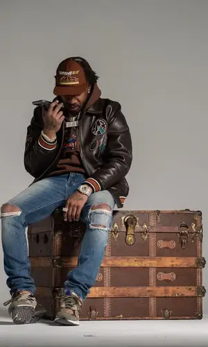 Benny The Butcher’s Outfit in Avirex Jacket, New Balance Sneakers & Supreme Cap (2023)