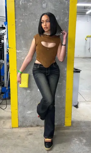 Jodie Woods’ Outfit in Vivienne Westwood Top, I.Am.Gia Jeans & Chanel Wallet (2023)