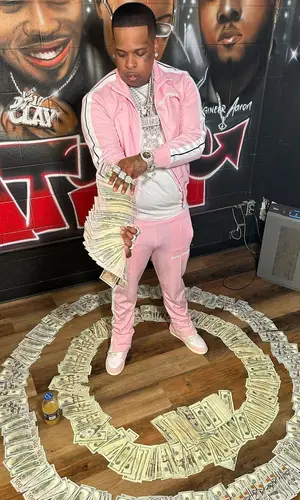 Finesse2tymes wearing Palm Angels jacket