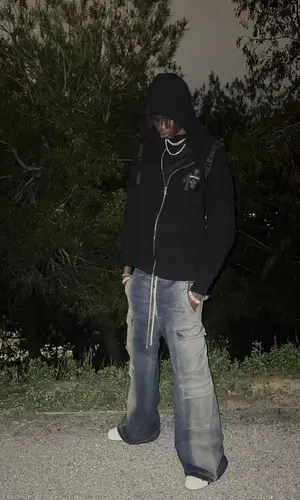 Bol Bol’s Outfit in Chrome Hearts Hoodie, Rick Owens Jeans & Converse Sneakers (2023)