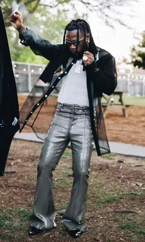 Burna Boy wearing Celine boots