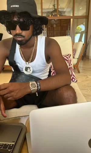 Mowgs wearing Louis Vuitton wallet