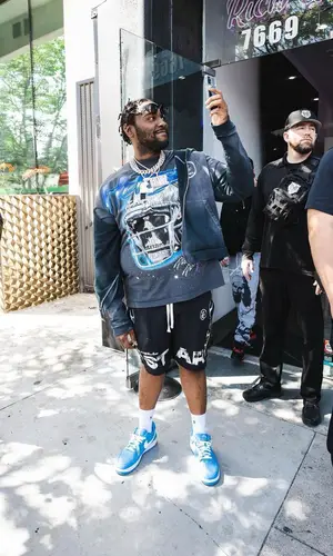 Peezy wearing Ralph Lauren sock