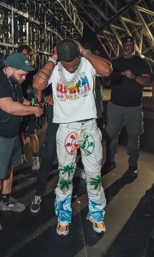 A Boogie Wit Da Hoodie wearing Who Decides War pants
