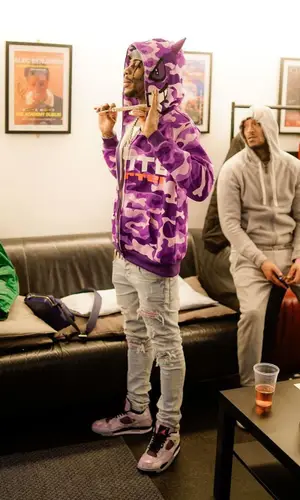 Russ Millions’ Outfit in Amiri Jeans, Jordan Sneakers & Louis Vuitton Bag (2023)