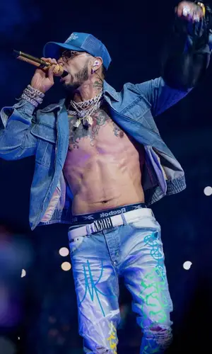 Anuel AA wearing Amiri cap