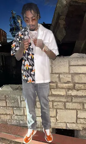 Lil Tjay wearing Prada belt