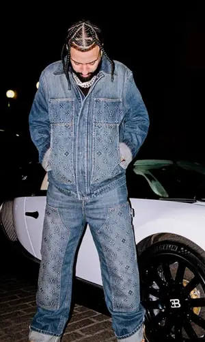 French Montana wearing Louis Vuitton jeans