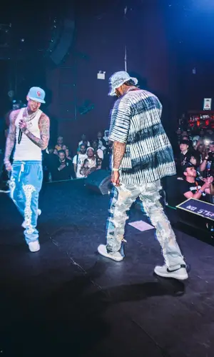 Dave East wearing Who Decides War hat