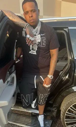 Finesse2tymes wearing Nike shorts