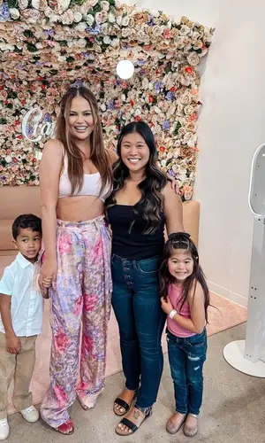 Chrissy Teigen’s Outfit in Hanro Top, Dries Van Noten Pants & Aquazzura Sandals (2023)