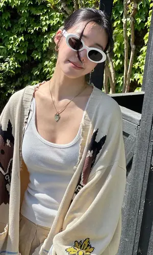 Tiffany Young’s Outfit in Profound Jacket, Miu Miu Bag & Crocs Sandals (2023)