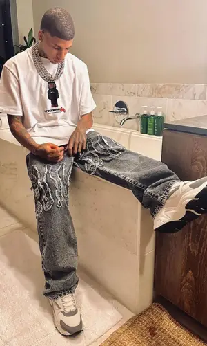 NLE Choppa wearing NLE Choppa Merch t-shirt