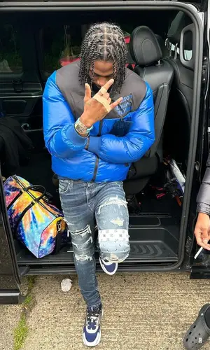 Russ Millions wearing Louis Vuitton bag