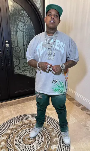Finesse2tymes wearing Purple Brand jeans