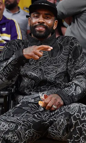 Kyrie Irving wearing Who Decides War shirt