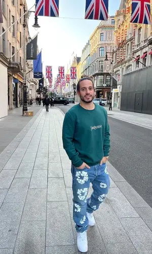 Russ wearing Denim Tears jeans