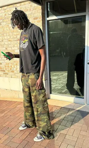 Bol Bol wearing Vintage t-shirt