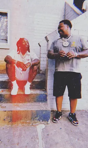 EST Gee wearing Heron Preston shorts