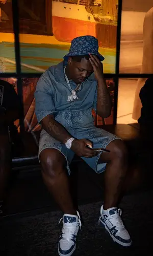 Lil Zay Osama wearing Louis Vuitton shorts