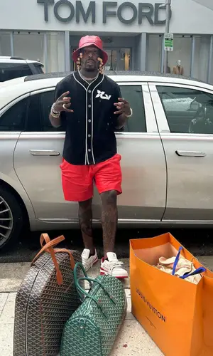 Sauce Walka wearing Goyard bag