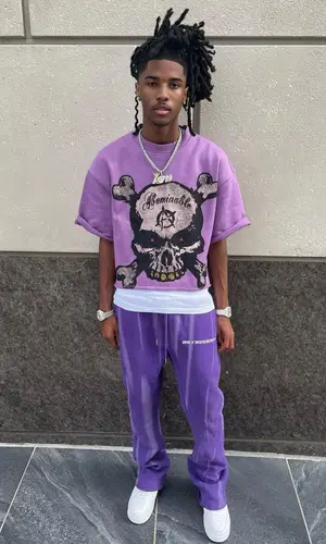 Lil Darius wearing Retrovert pants