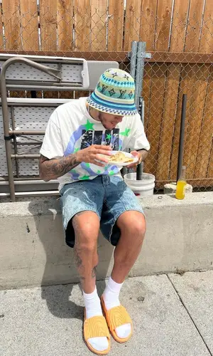 Kyle Kuzma’s Outfit in Saint Michael T-Shirt, Louis Vuitton Hat & Crocs Sandals (2023)