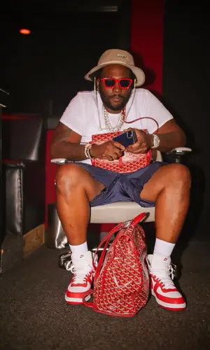 Peezy wearing Goyard backpack