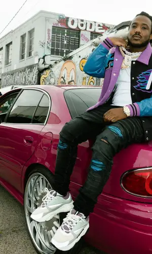 Mozzy wearing Amiri jeans