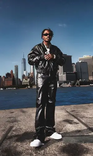 Lil Tjay wearing BooHooMan trousers