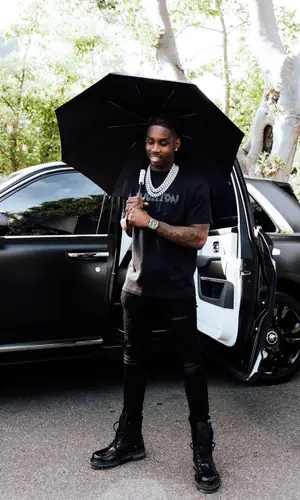 Polo G wearing Louis Vuitton boots