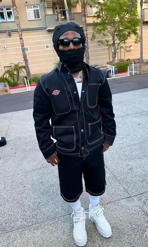 Jacquees wearing Celine boots