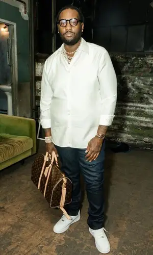 Peezy wearing Louis Vuitton shirt