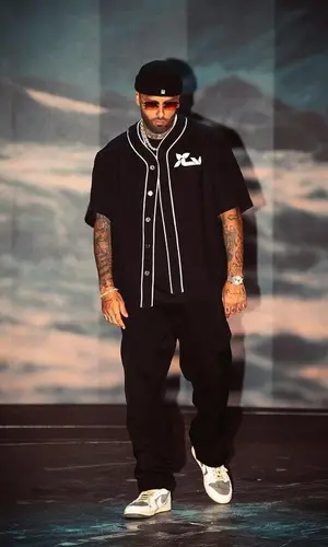 Nicky Jam’s Outfit in Louis Vuitton Shirt, Nike Sneakers & Cartier Eyewear (2023)