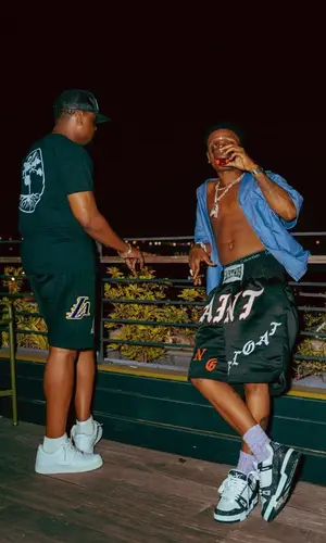 Wizkid’s Outfit in Prada Shirt, Saint Michael Shorts & Louis Vuitton Sneakers (2023)