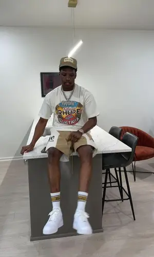 Rob49 wearing Rhude cap