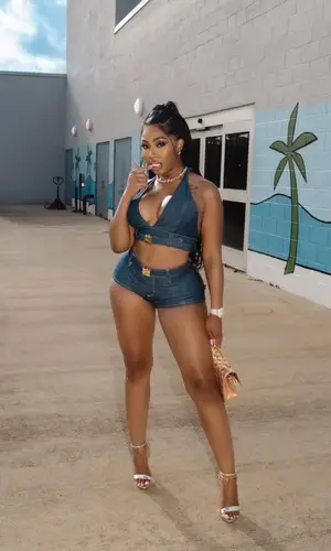 Yung Miami’s Outfit in Miu Miu Top & Chanel Bag (2023)
