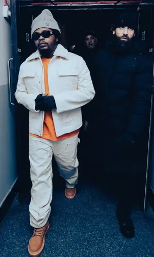 Olamide wearing Louis Vuitton pants