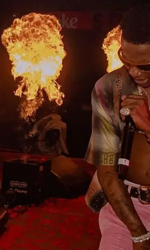 Wizkid’s Outfit in Givenchy Shirt, Loewe Trousers & Nike Sneakers (2023)
