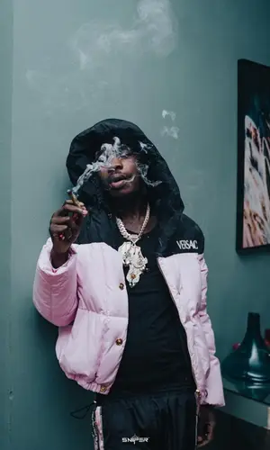 Naira Marley wearing Off-White sneakers