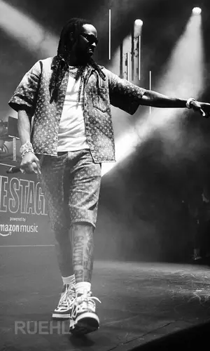 2 Chainz wearing Louis Vuitton shirt