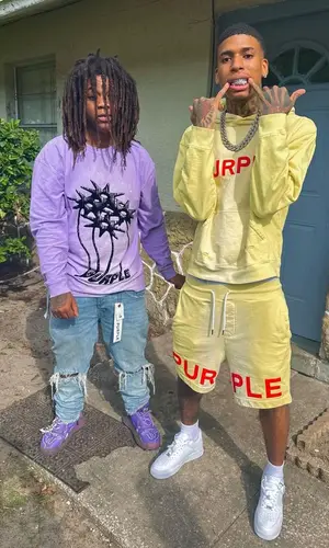 NLE Choppa wearing Purple Brand shorts